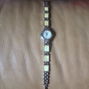 Gorgeous silver watch with yellow stones in band!